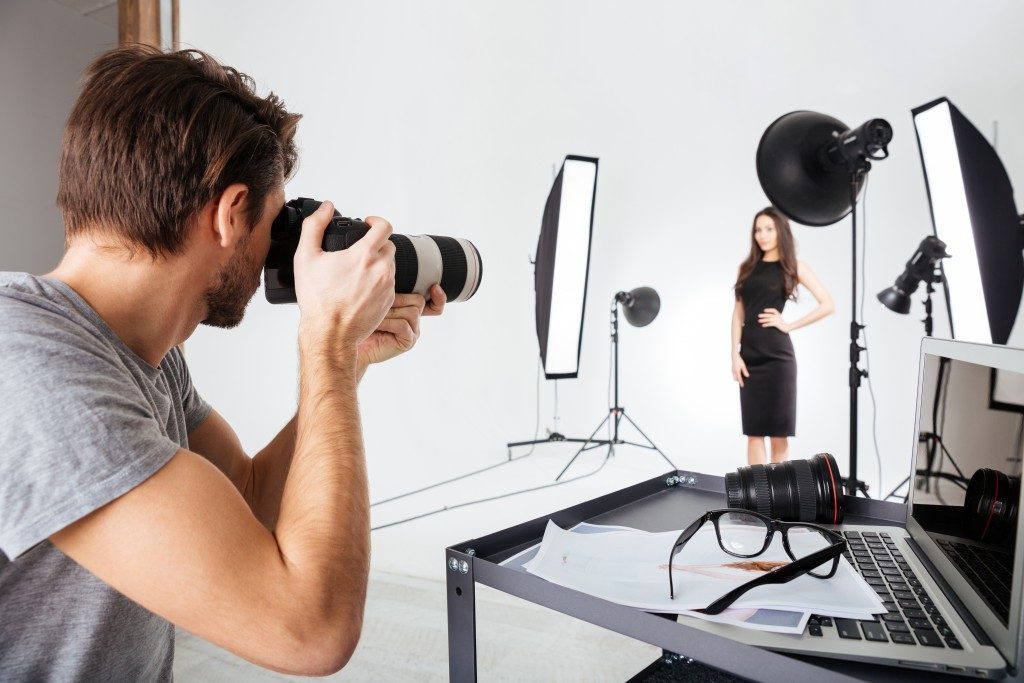 photographer and model in a studio