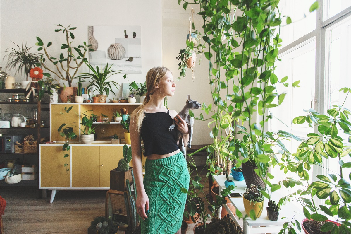 woman with a house full of plants