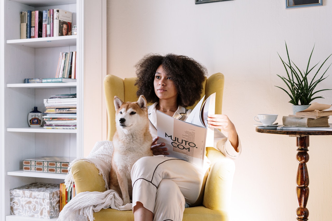woman reading a magazine with her dog