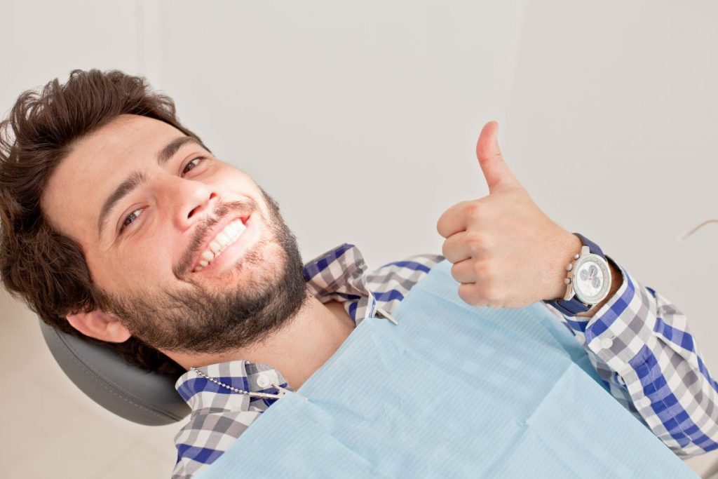 man smiling while at the dentists