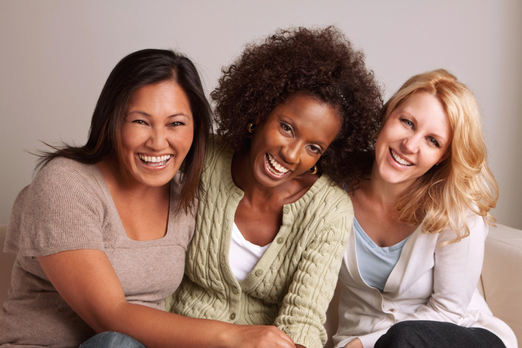 Women coming from different races smiling together