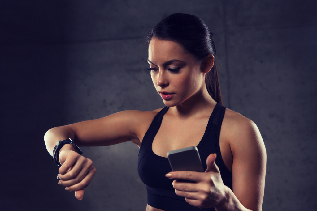 A woman using a fitness tracker