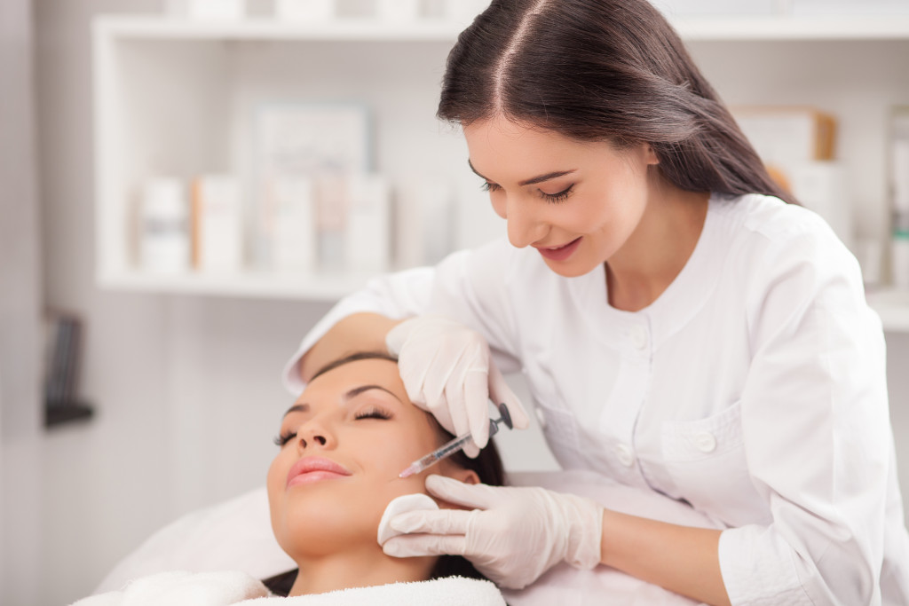 A women getting a facial esthetic procedure