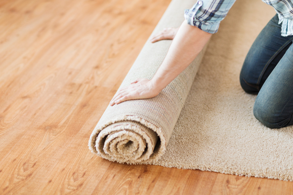 woman rolling a carpet