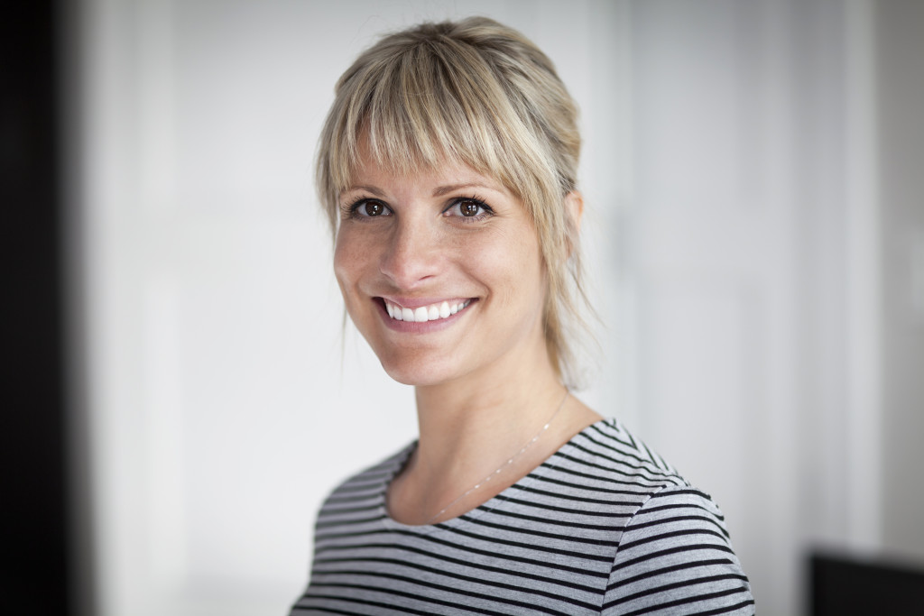 Smiling mature woman wearing a striped shirt.