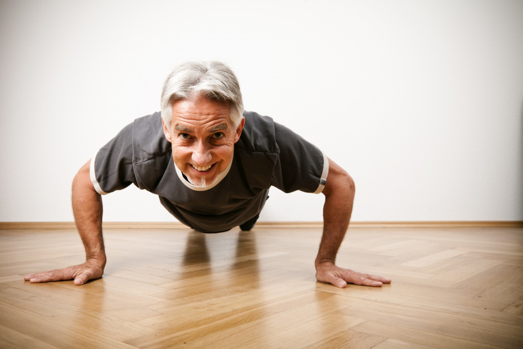 a senior man doing push-ups