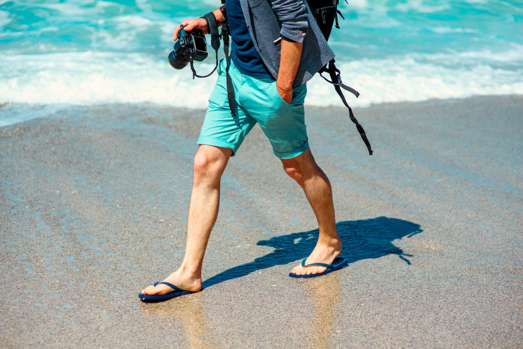photographer walking at the beach