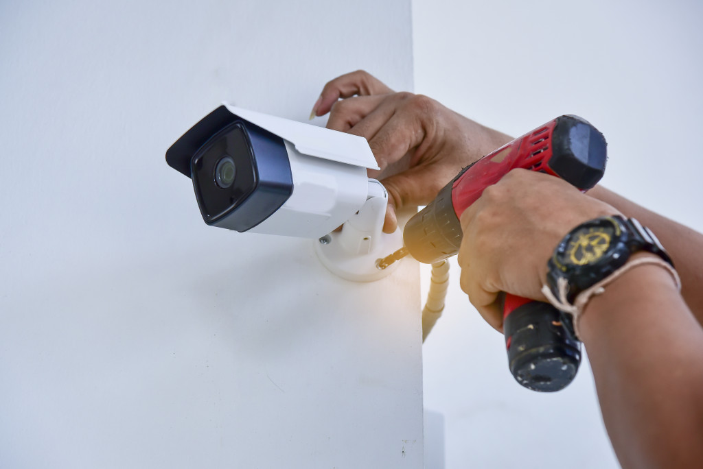 person installing smart security camera home